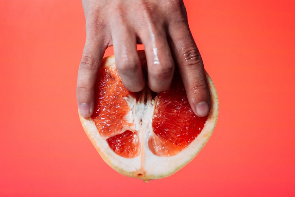 Sliced grapefruit being fingered